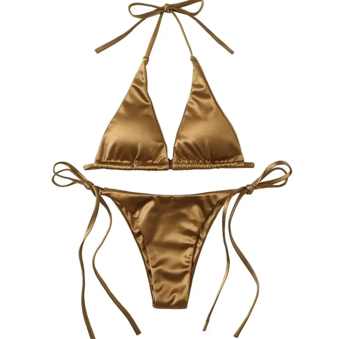 golden bikini, A bikini set featuring triangular soft cups with removable padding, and adjustable neck and back ties. The shiny, silky fabric maintains its luster even after swimming in the sea. The bottoms have side-tie fastenings for a personalized fit. Made from 80% polyamide and 20% elastane, this bikini is designed for comfort and style.