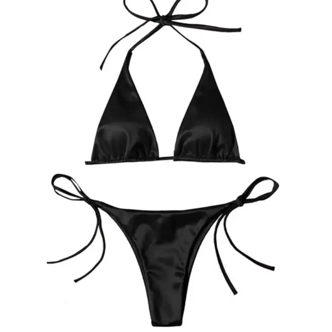 Black Bikini, A bikini set featuring triangular soft cups with removable padding, and adjustable neck and back ties. The shiny, silky fabric maintains its luster even after swimming in the sea. The bottoms have side-tie fastenings for a personalized fit. Made from 80% polyamide and 20% elastane, this bikini is designed for comfort and style.